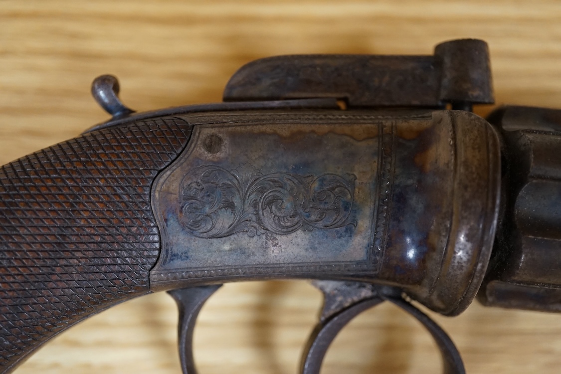 A six shot 80 bore, self-cocking, pepperbox revolver signed; W. Dooley, Liverpool, with foliate engraved frame and fluted barrel, Birmingham proved, and one piece rounded chequered walnut grip, together with a small copp